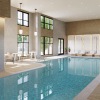 indoor swimming pool with chairs around it