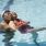 older couple laugh together in pool